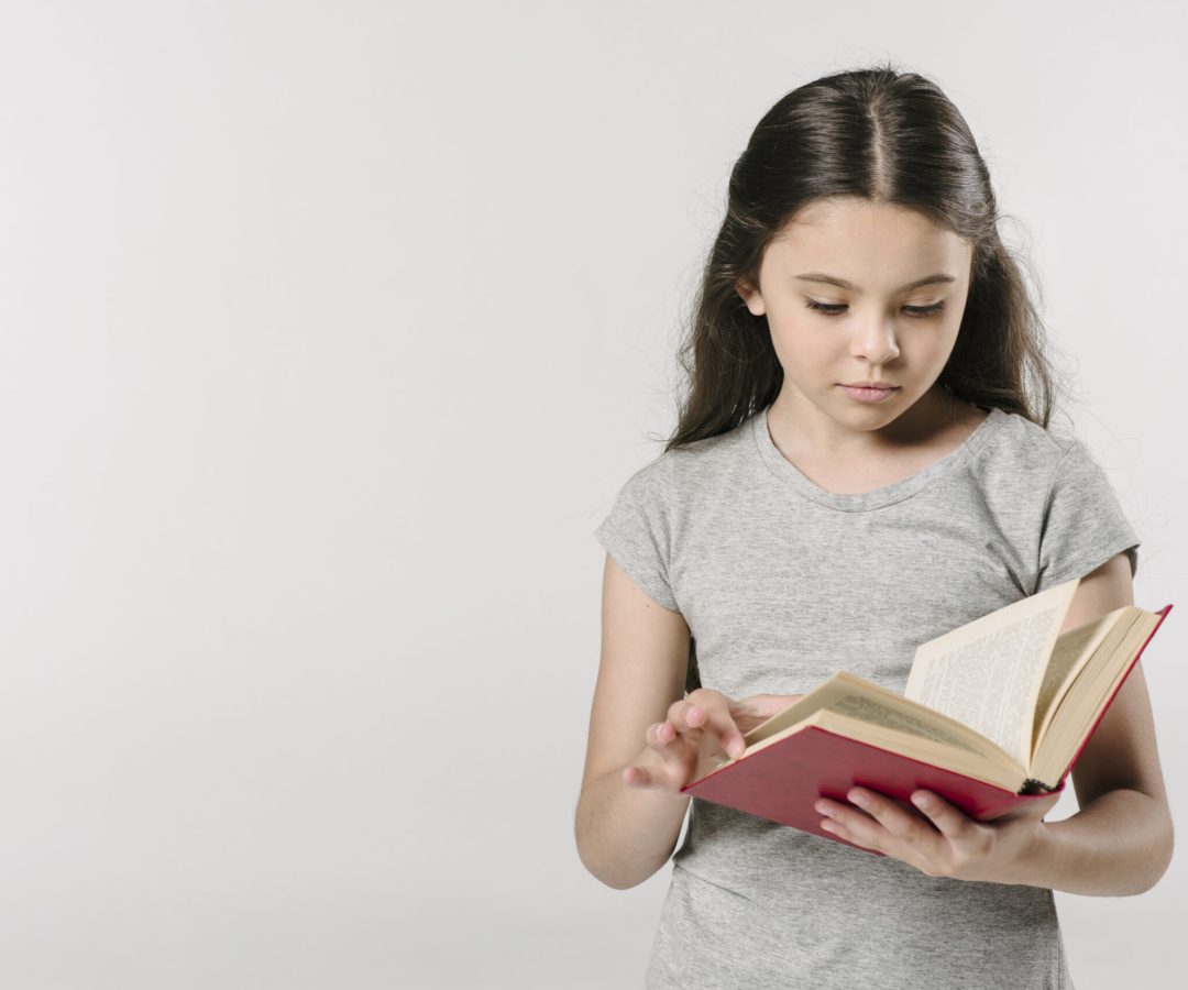 junior-girl-reading-book-studio